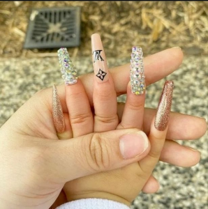 Mum slammed for fixing her baby’s nails with extra long artificial ones