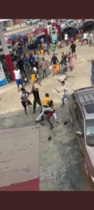 Youths seen fighting with sticks at a fuel station (video)